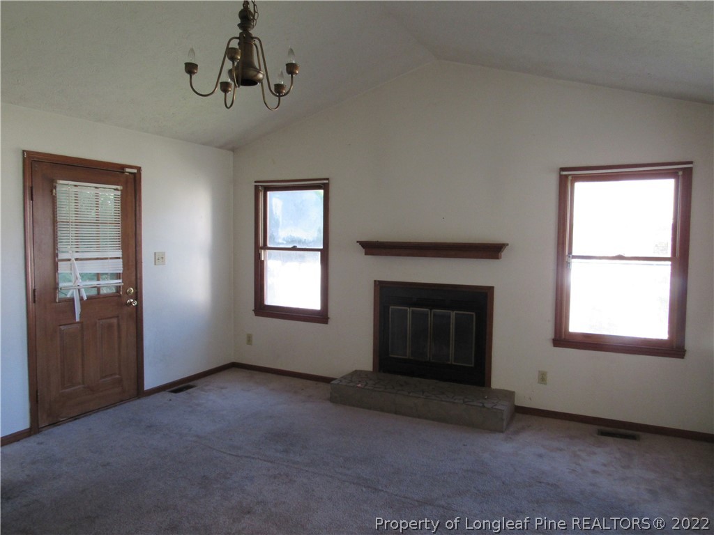 609 Jennings Farm Road Fayetteville, NC 28314 - Photo 2 of 6 an empty room with windows and fireplace