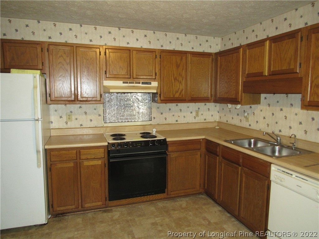 609 Jennings Farm Road Fayetteville, NC 28314 - Photo 3 of 6 a kitchen with stainless steel appliances granite countertop a sink stove and refrigerator