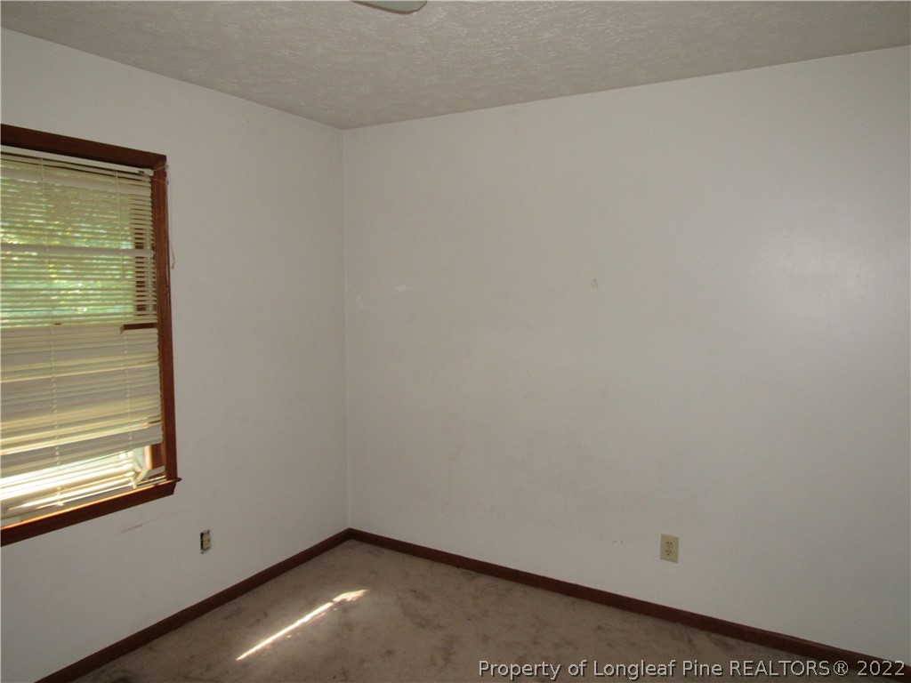 609 Jennings Farm Road Fayetteville, NC 28314 - Photo 4 of 6 a view of an empty room with a window