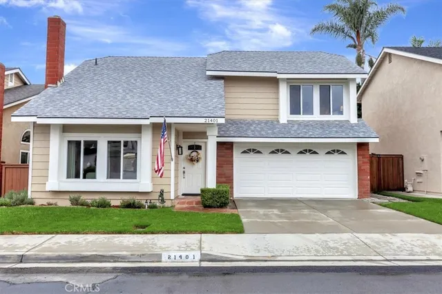 a front view of a house with a yard and a garage