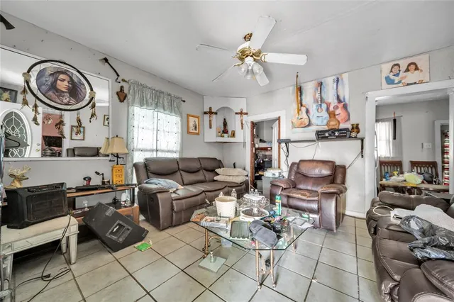 a living room with furniture a fireplace and a window