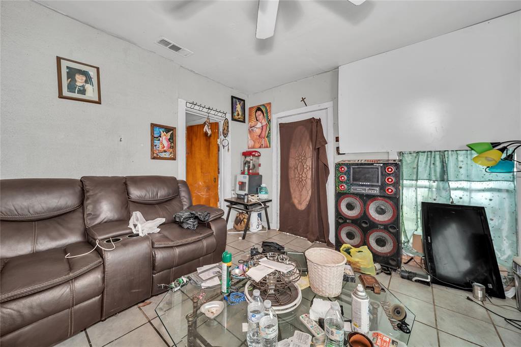 2746 Sharon Street Dallas, TX 75211 - Photo 7 of 9 a living room with furniture a flat screen tv and a fireplace
