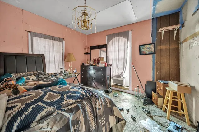 a bed room with a bed and a chair