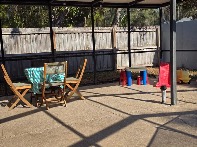 a view of a chairs and table in patio