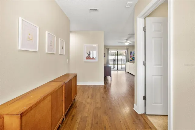 a view of a hallway with wooden floor