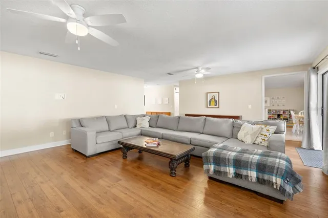 a living room with furniture and a wooden floor