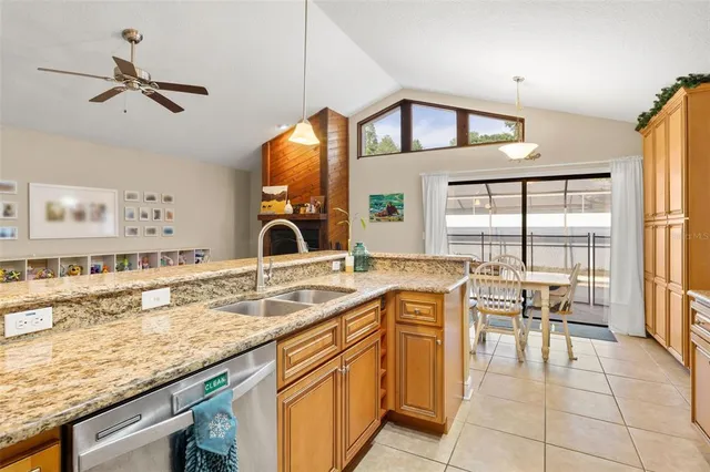 a kitchen with stainless steel appliances granite countertop a sink and a stove