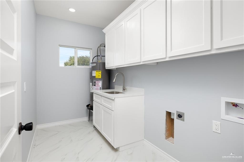 3708 Canan Street Weslaco, TX 78596 - Photo 11 of 13 a kitchen with white cabinets and sink