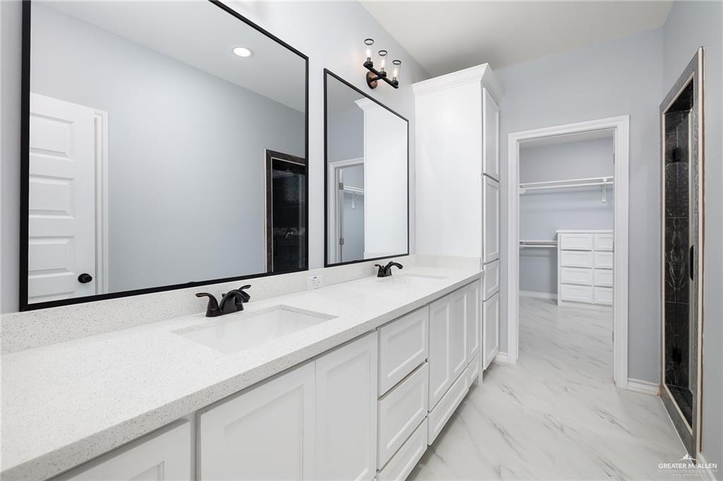 3708 Canan Street Weslaco, TX 78596 - Photo 7 of 13 a bathroom with a double vanity sink and mirror