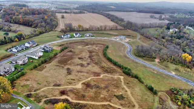 an aerial view of a house with a yard and lake