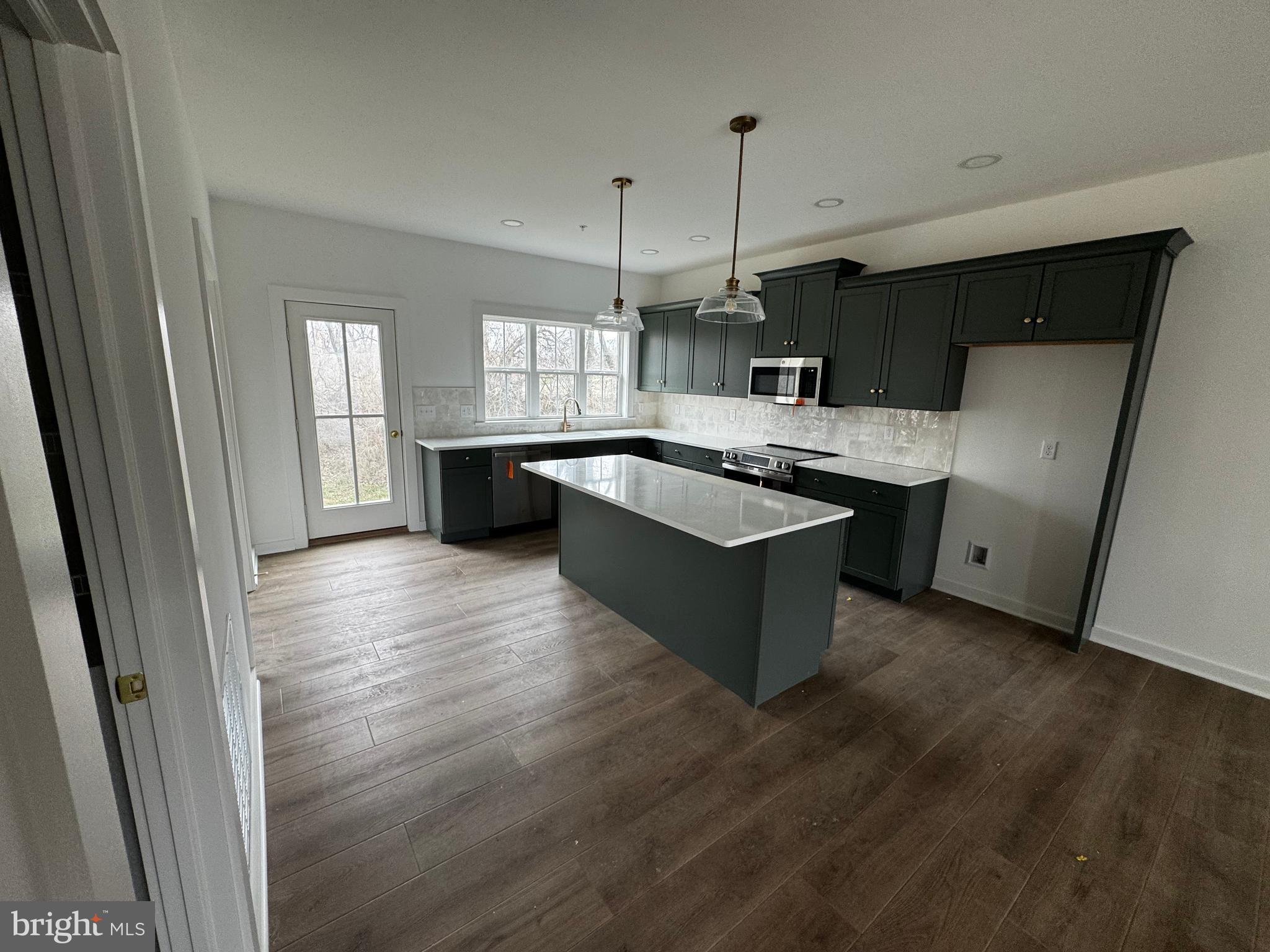 185 Trailside Court Lebanon, PA 17042 - Photo 4 of 17 a kitchen with stainless steel appliances granite countertop a sink a refrigerator a stove a microwave and wooden floors