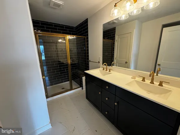 a bathroom with a sink vanity and a mirror