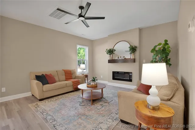 a living room with furniture and a fireplace