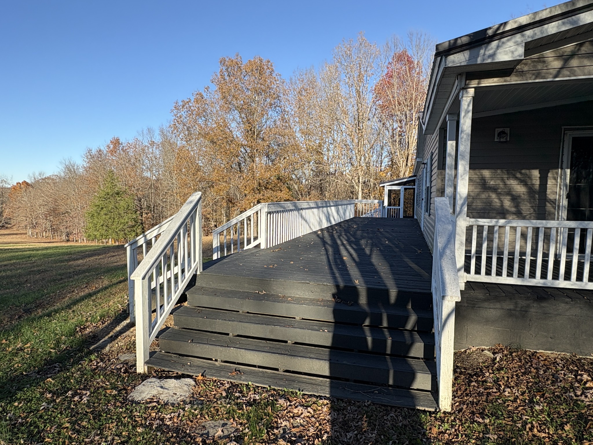a view of a balcony with wooden floor and wooden fence