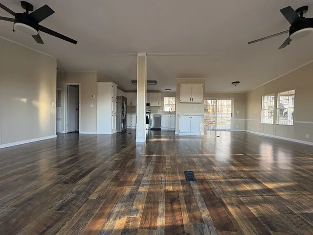 a kitchen with stainless steel appliances granite countertop a refrigerator a stove top oven a sink and dishwasher