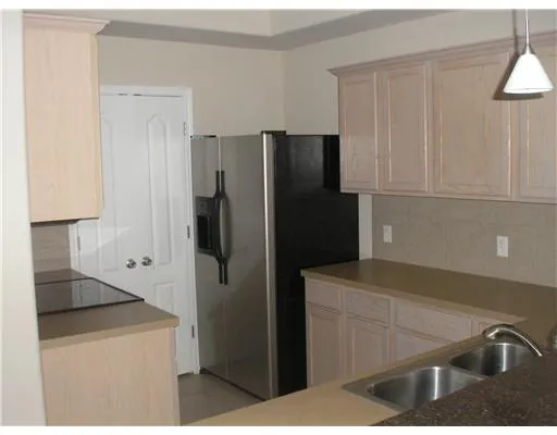 a kitchen with a refrigerator and a sink