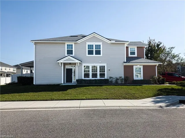 a front view of a house with a yard and garage