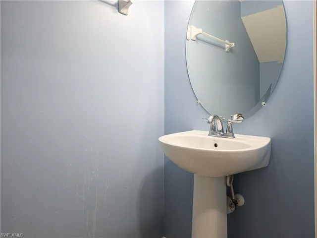 a bathroom with a sink a mirror and vanity