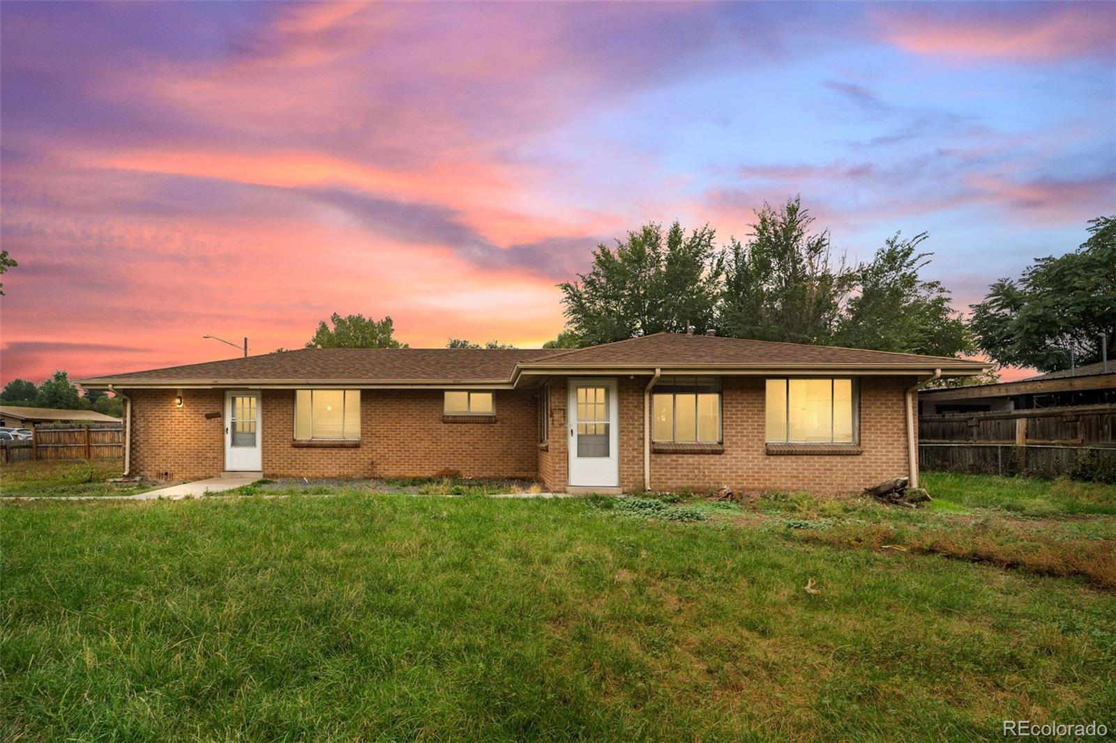 a front view of house with yard and green space