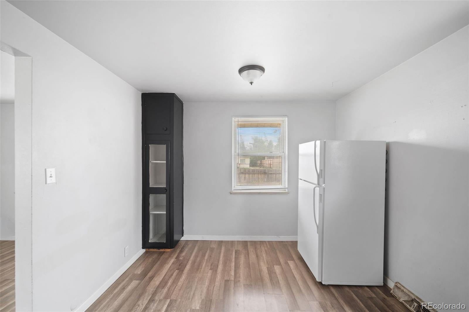 4785 Carr Street Wheat Ridge, CO 80033 - Photo 11 of 27 an empty room with wooden floor and a window