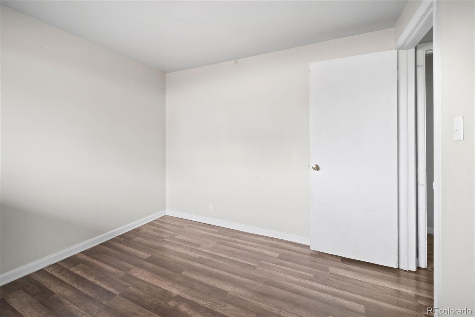 4785 Carr Street Wheat Ridge, CO 80033 - Photo 16 of 27 an empty room with wooden floor