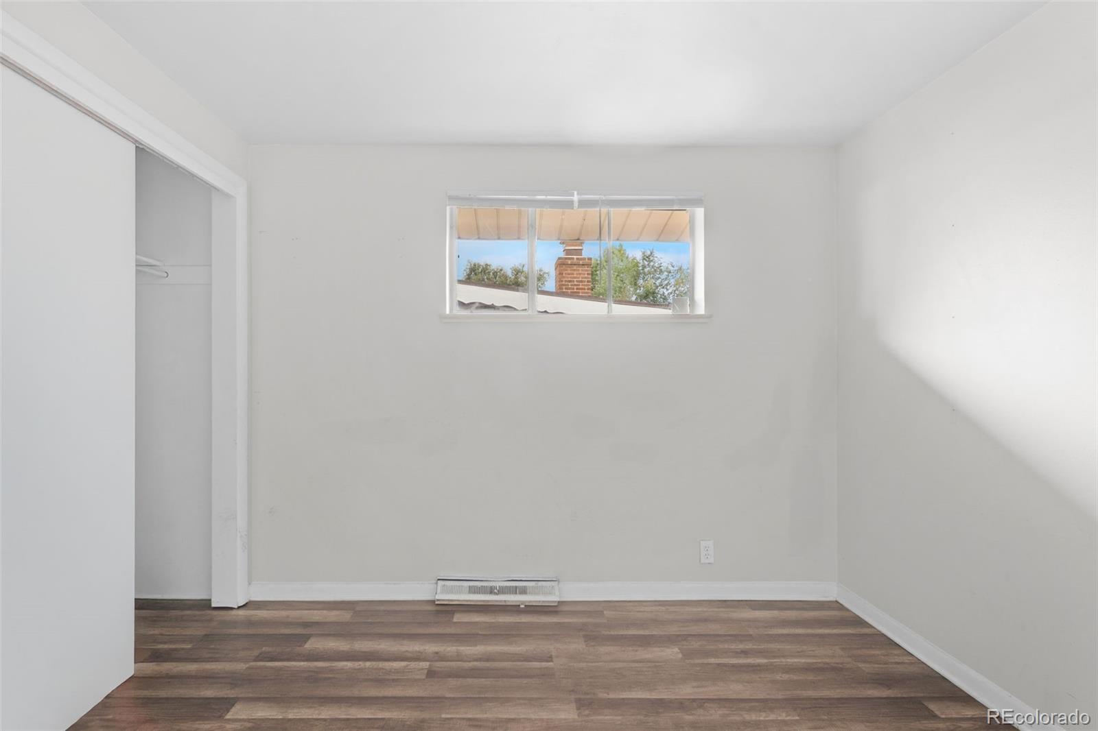 4785 Carr Street Wheat Ridge, CO 80033 - Photo 19 of 27 a view of an empty room with wooden floor