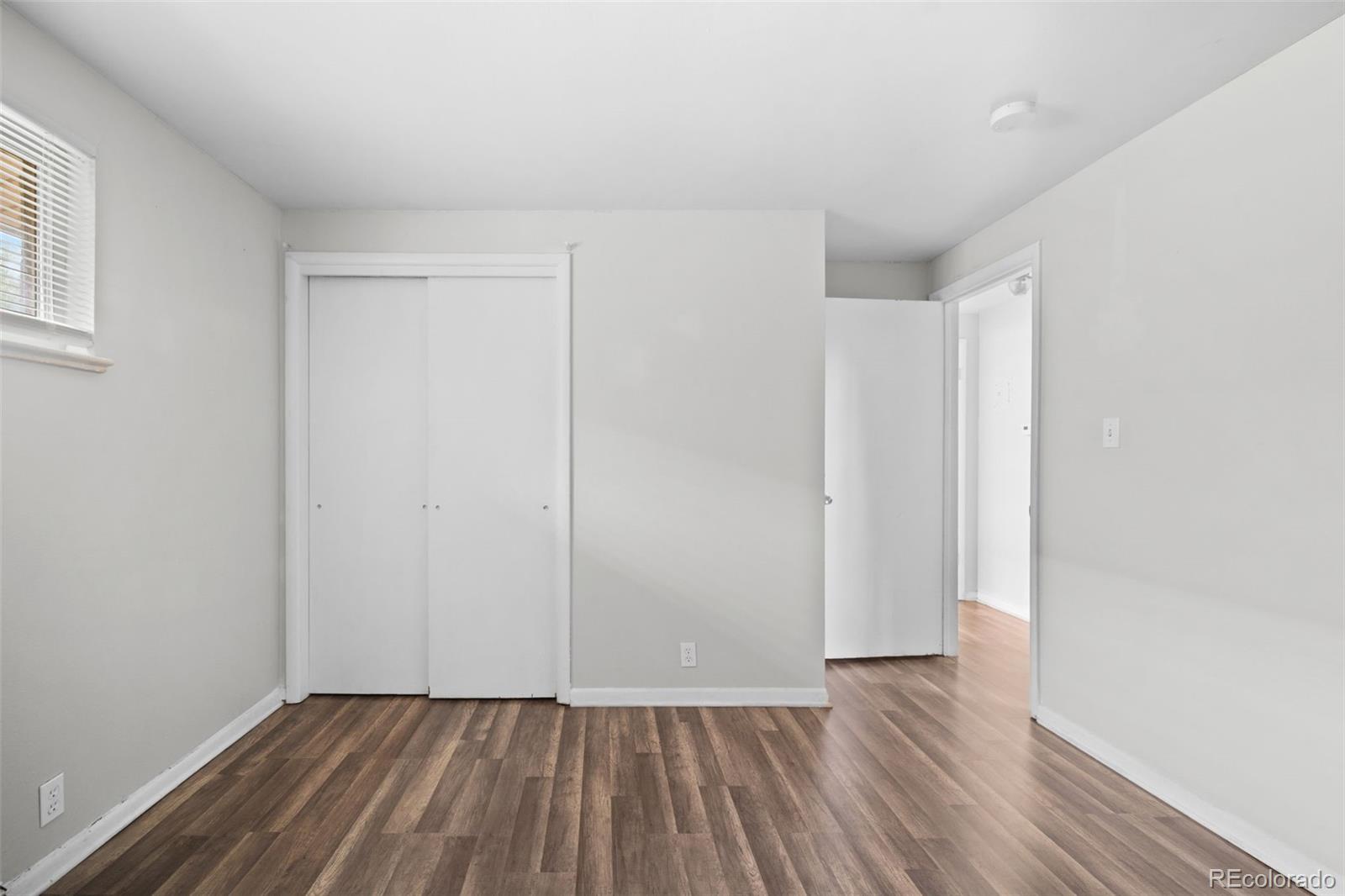 4785 Carr Street Wheat Ridge, CO 80033 - Photo 20 of 27 a view of an empty room with wooden floor