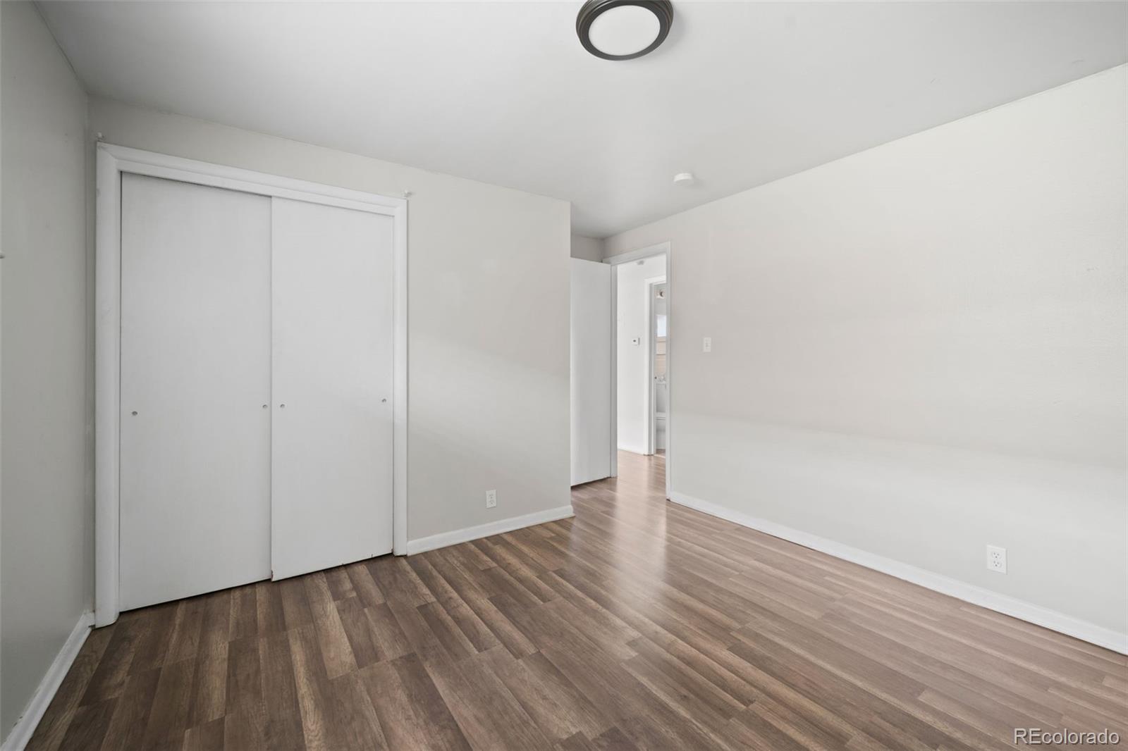 4785 Carr Street Wheat Ridge, CO 80033 - Photo 23 of 27 a view of an empty room with wooden floor