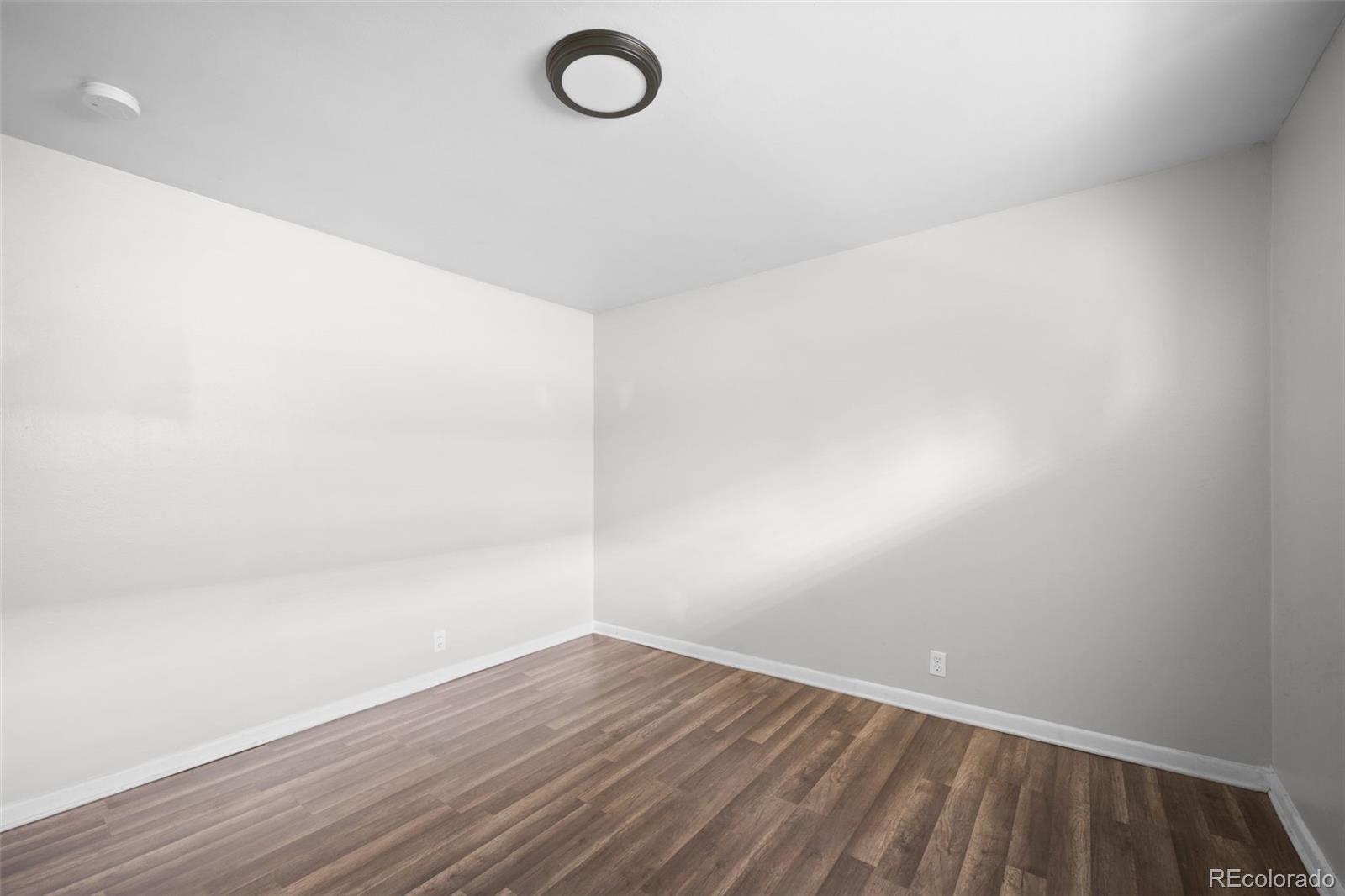 4785 Carr Street Wheat Ridge, CO 80033 - Photo 24 of 27 a view of a room with wooden floor