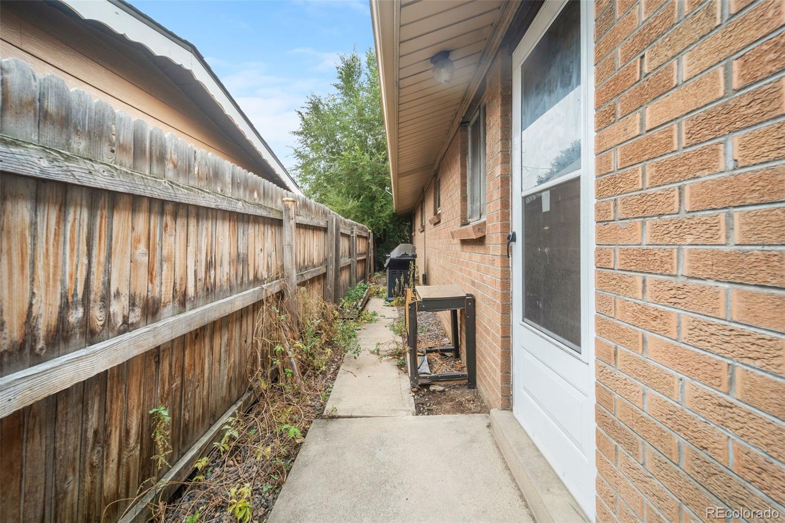 4785 Carr Street Wheat Ridge, CO 80033 - Photo 26 of 27 a balcony with wooden floor and outdoor seating