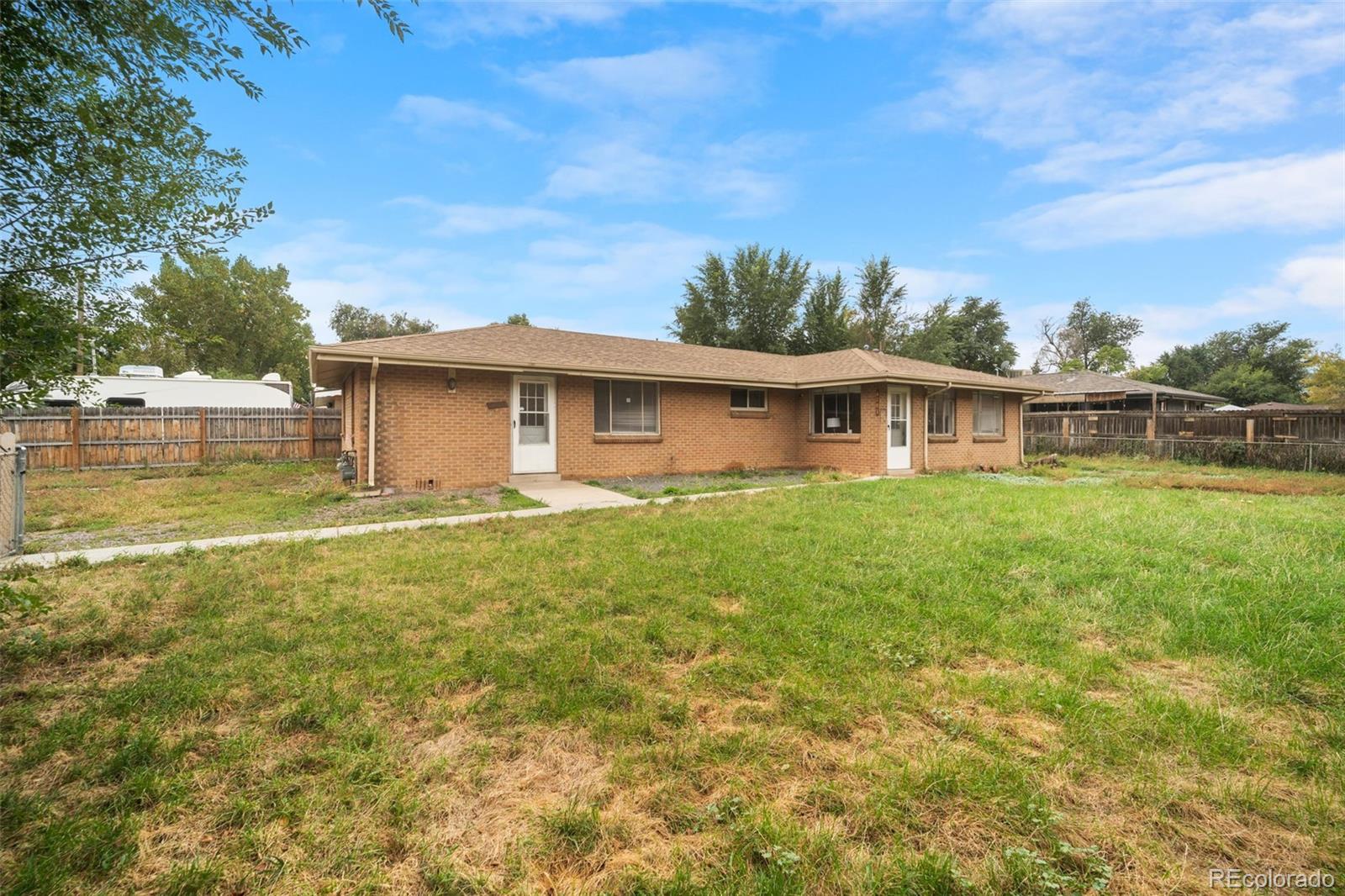 4785 Carr Street Wheat Ridge, CO 80033 - Photo 3 of 27 a view of a house with a garden and lake view