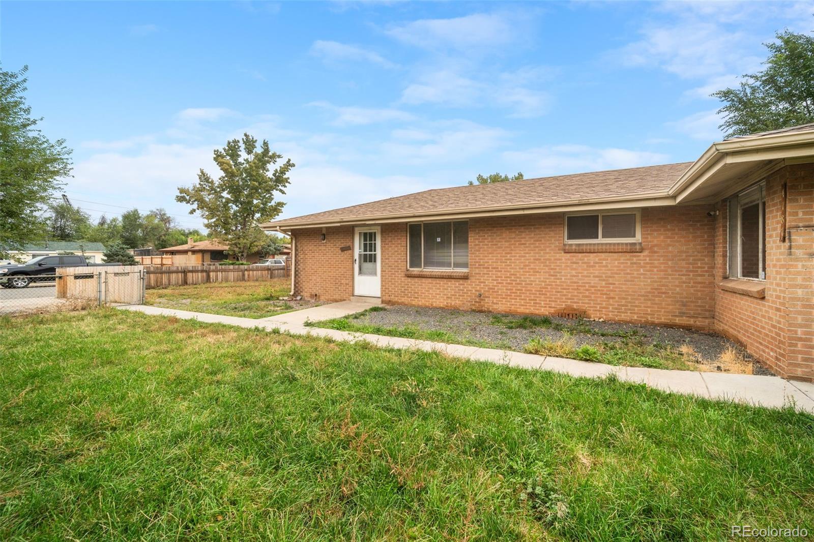 4785 Carr Street Wheat Ridge, CO 80033 - Photo 4 of 27 a backyard of a house with lots of green space