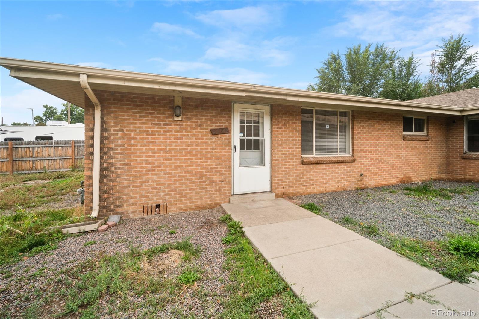 4785 Carr Street Wheat Ridge, CO 80033 - Photo 5 of 27 a backyard of a house with lots of green space
