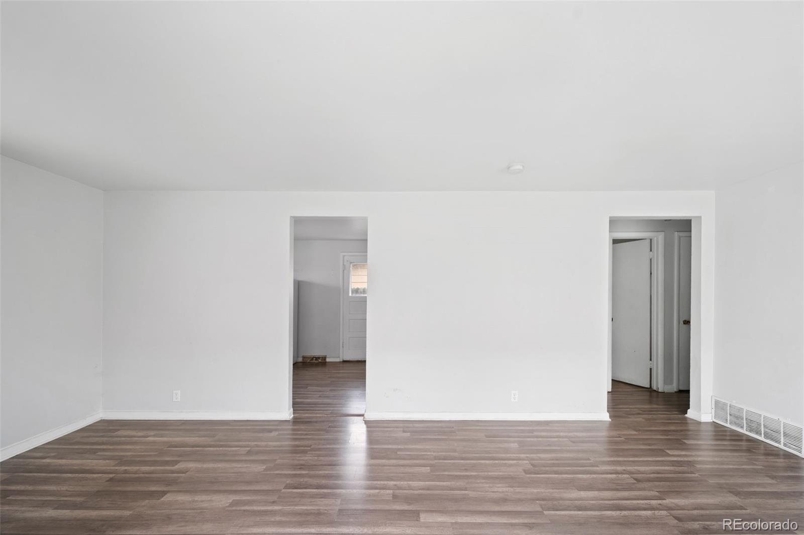 4785 Carr Street Wheat Ridge, CO 80033 - Photo 8 of 27 a view of an empty room and wooden floor