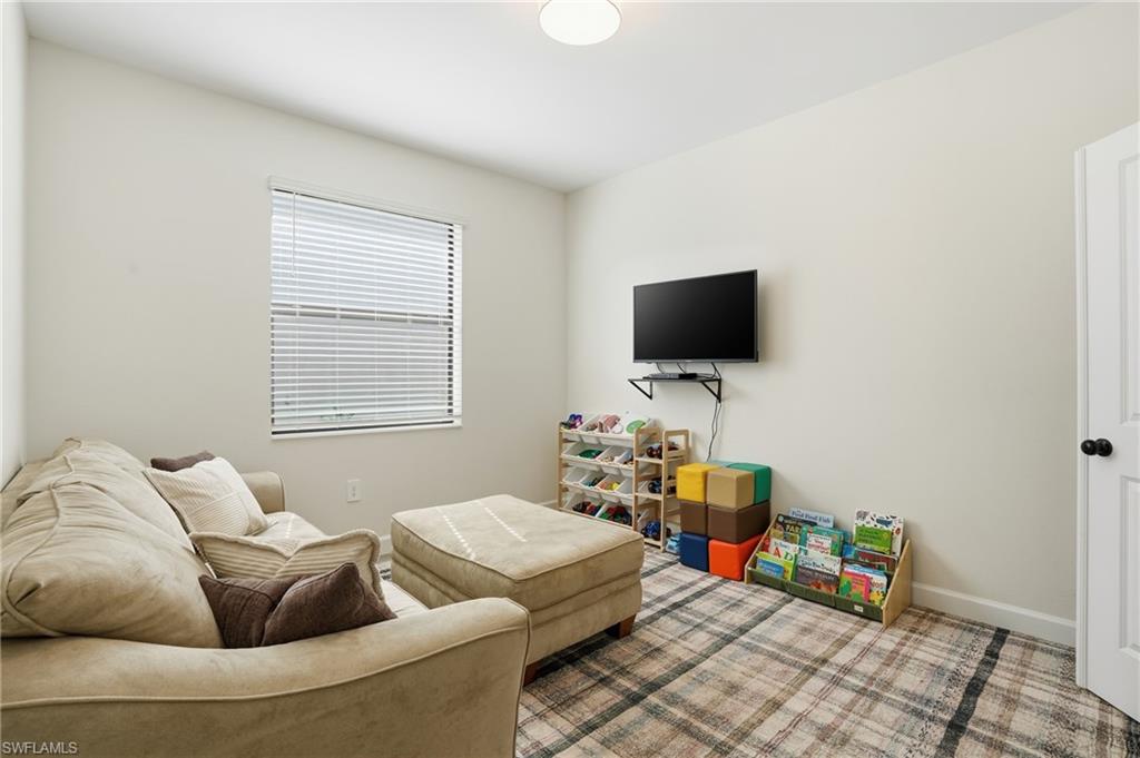 19306 Hinkley Drive Estero, FL 33928 - Photo 12 of 49 a living room with furniture and a flat screen tv