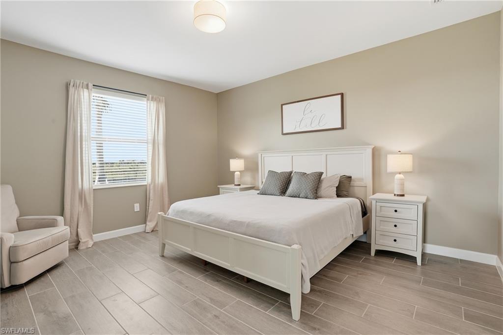 19306 Hinkley Drive Estero, FL 33928 - Photo 13 of 49 a bedroom with a bed and a couch