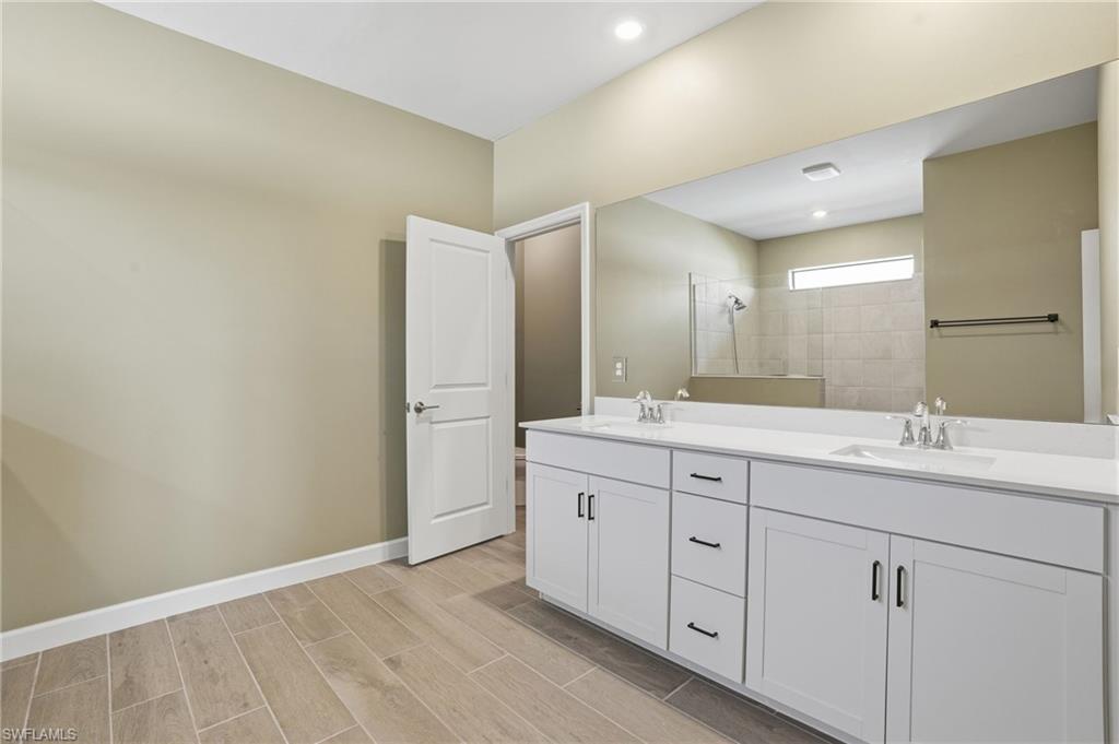 19306 Hinkley Drive Estero, FL 33928 - Photo 16 of 49 a bathroom with a double vanity sink and mirror