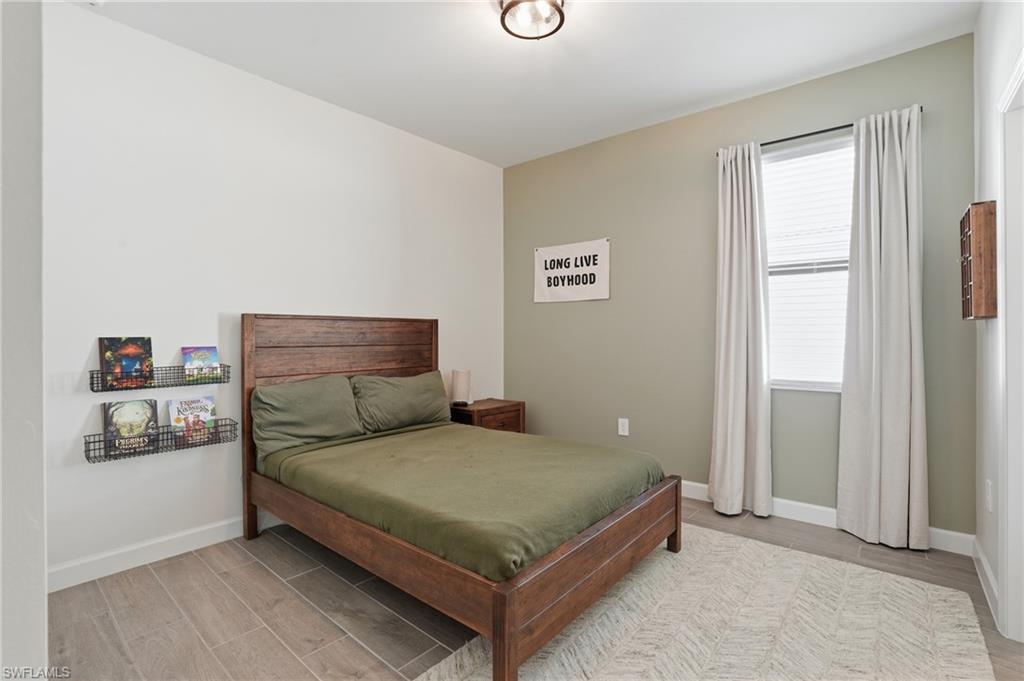 19306 Hinkley Drive Estero, FL 33928 - Photo 18 of 49 a bedroom with a bed and a window