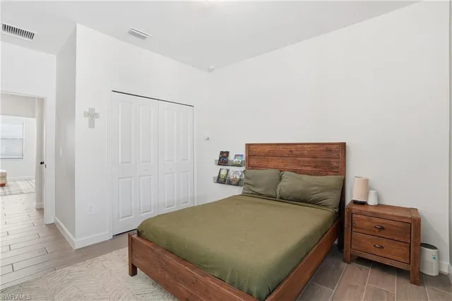 a bedroom with a bed and a book shelf
