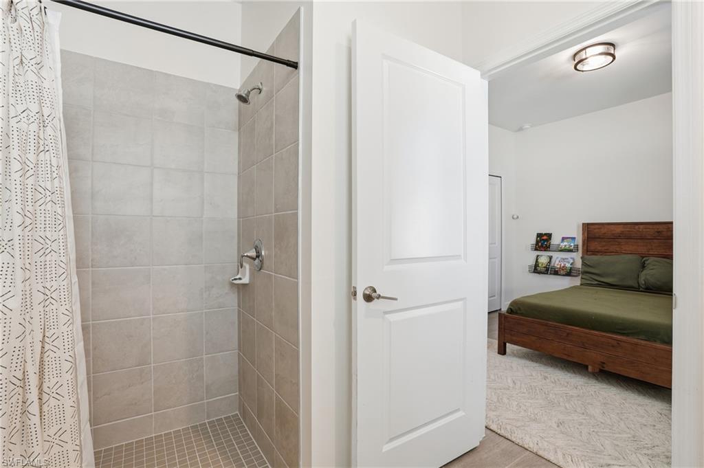 19306 Hinkley Drive Estero, FL 33928 - Photo 21 of 49 a en suite bathroom with a double vanity sink and a mirror