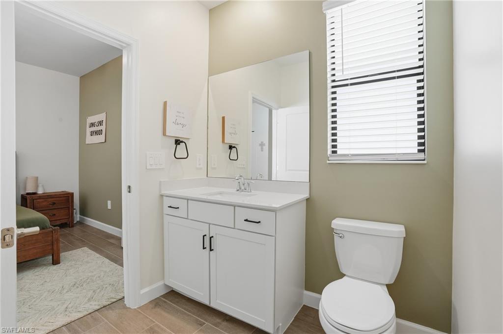 19306 Hinkley Drive Estero, FL 33928 - Photo 22 of 49 a bathroom with a toilet sink and mirror