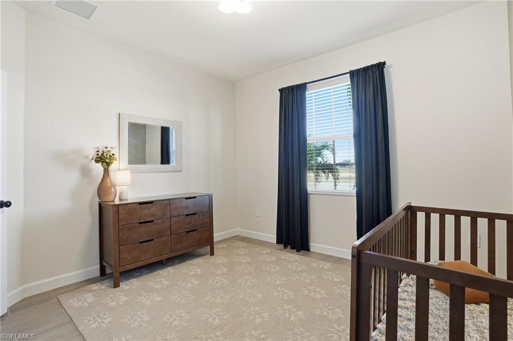 19306 Hinkley Drive Estero, FL 33928 - Photo 24 of 49 a bedroom with a bed and a window