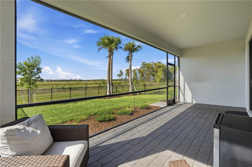 19306 Hinkley Drive Estero, FL 33928 - Photo 29 of 49 a view of a porch with furniture and garden