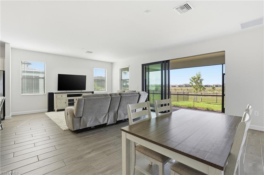 19306 Hinkley Drive Estero, FL 33928 - Photo 3 of 49 a living room with furniture and a flat screen tv