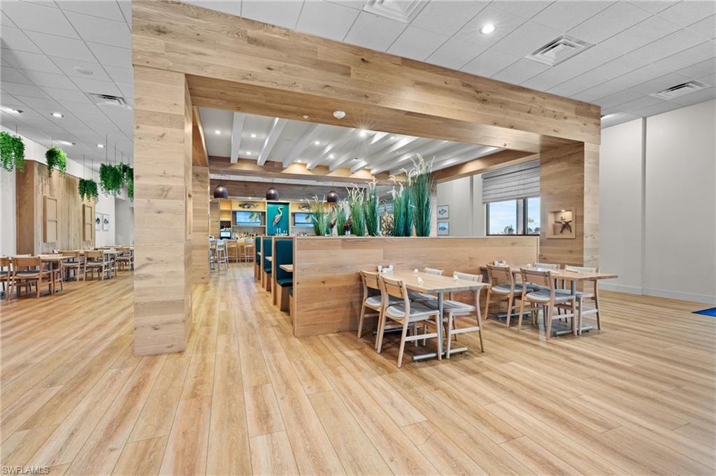 19306 Hinkley Drive Estero, FL 33928 - Photo 37 of 49 a view of a dining hall with furniture and wooden floor