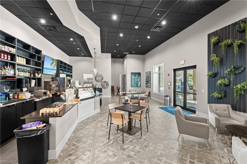 19306 Hinkley Drive Estero, FL 33928 - Photo 38 of 49 a living room with furniture and a book shelf