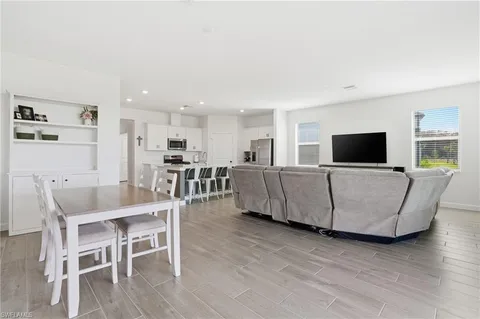 a living room with furniture and kitchen view