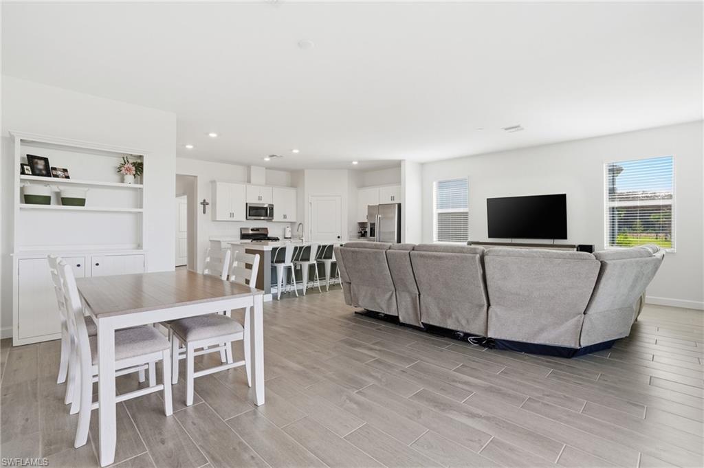 19306 Hinkley Drive Estero, FL 33928 - Photo 4 of 49 a living room with furniture and a flat screen tv