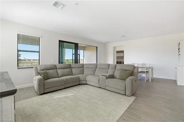 a kitchen with a sink a stove a refrigerator and white cabinets