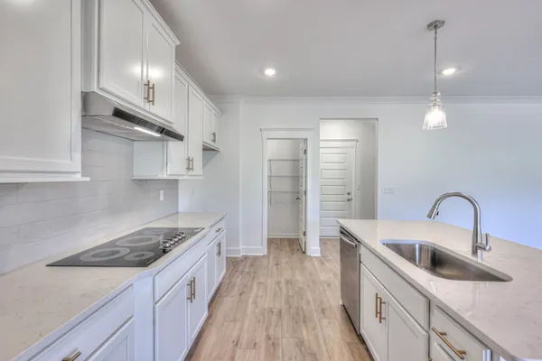 a kitchen with stainless steel appliances granite countertop a sink stove and cabinets